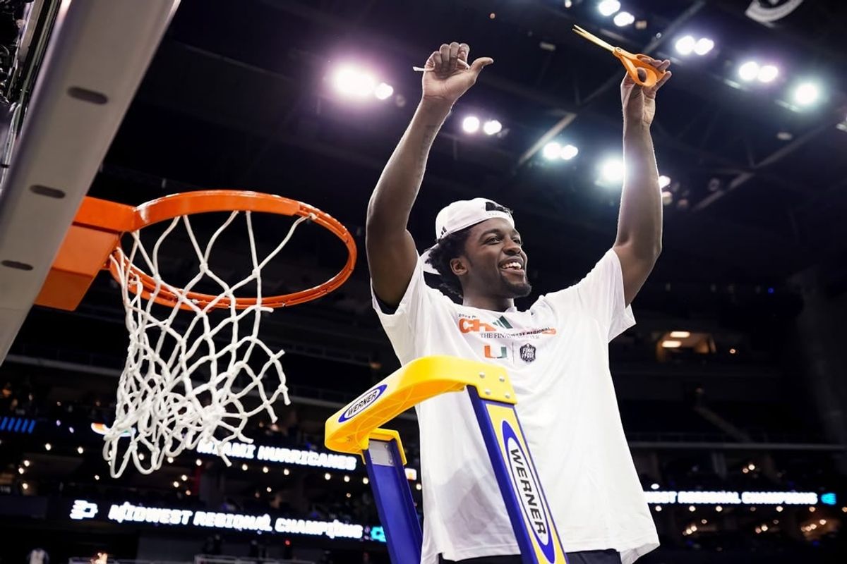 Mar 26, 2023; Kansas City, MO, USA; Miami (Fl) Hurricanes guard Bensley Joseph (4) cuts down the net after defeating the Texas Longhorns in an Elite 8 college basketball game in the Midwest Regional of the 2023 NCAA Tournament at T-Mobile Center.