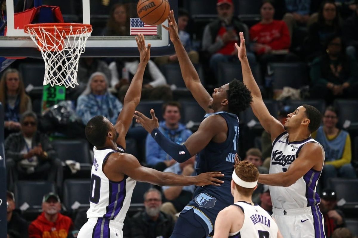 Jan 29, 2024; Memphis, Tennessee, USA; Memphis Grizzlies forward-center Jaren Jackson Jr. (13) shoots between Sacramento Kings forward Harrison Barnes (40)and Sacramento Kings forward Keegan Murray (13) during the first half at FedExForum.