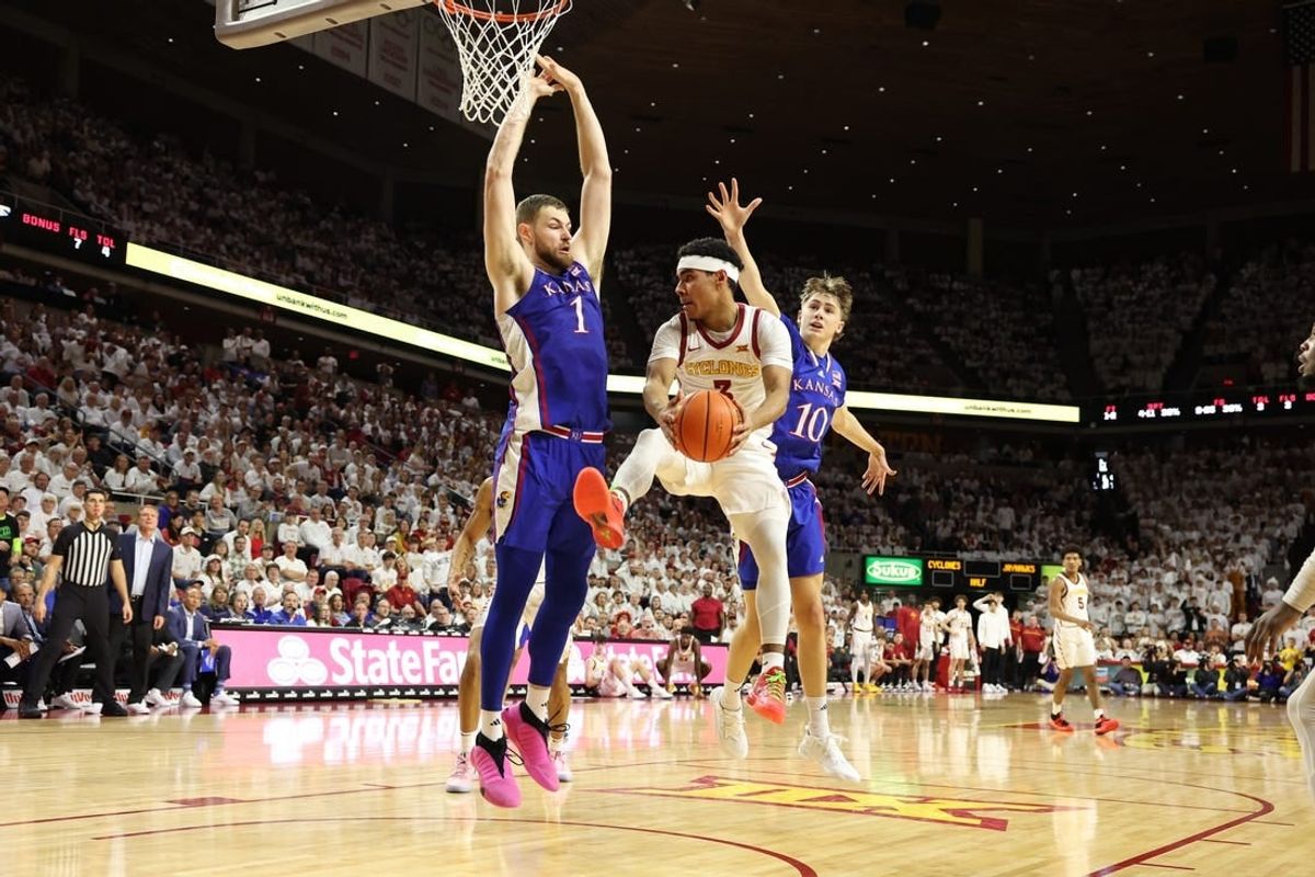 Feb 4, 2023; Ames, Iowa, USA; Iowa State Cyclones guard Tamin Lipsey (3) is trapped by Kansas Jayhawks center Hunter Dickinson (1) and guard Johnny Furphy (10) at James H. Hilton Coliseum.