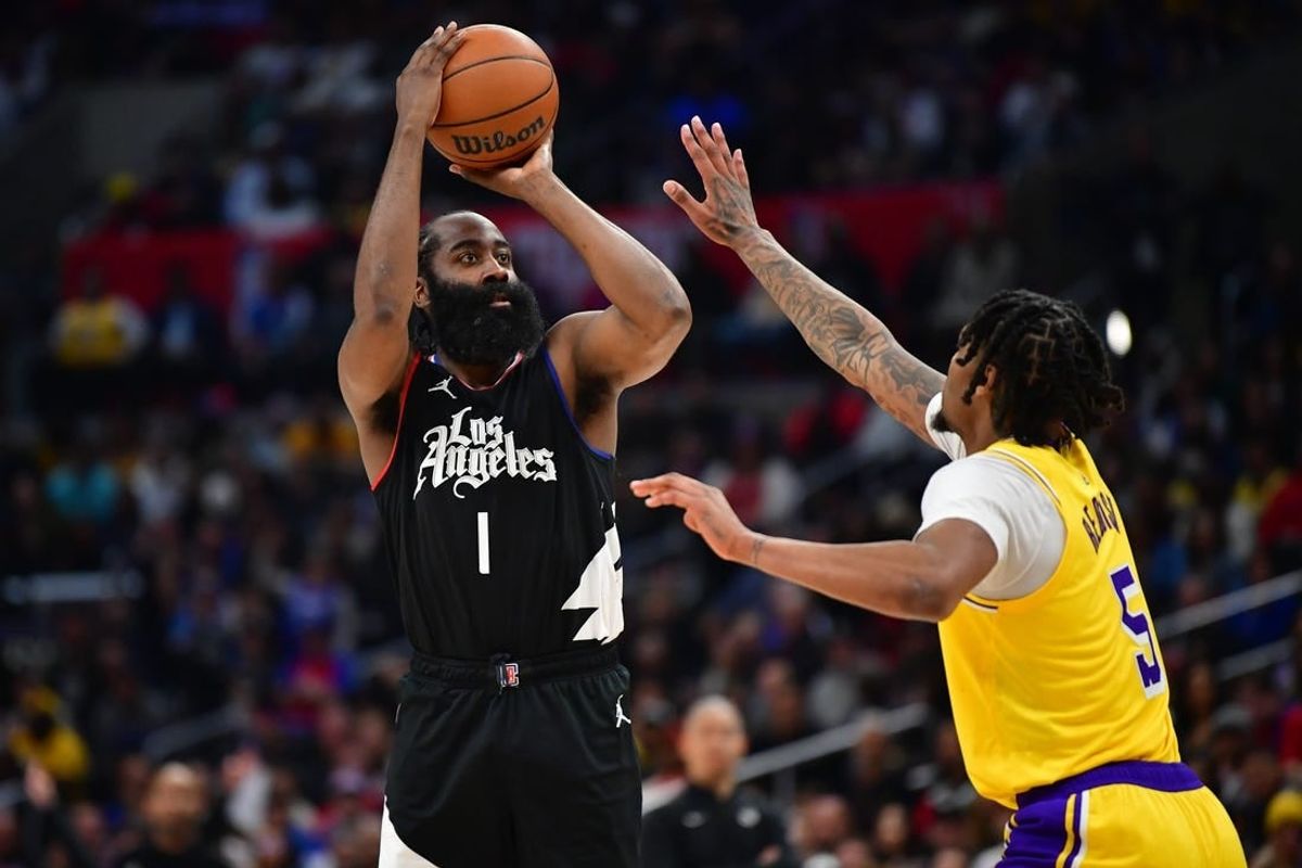 Feb 28, 2024; Los Angeles, California, USA; Los Angeles Clippers guard James Harden (1) shoots against Los Angeles Lakers forward Cam Reddish (5) during the second half at Crypto.com Arena.