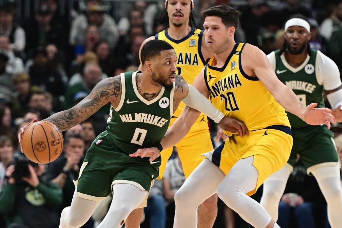 Apr 21, 2024; Milwaukee, Wisconsin, USA; Milwaukee Bucks guard Damian Lillard (0) drives for the basket against Indiana Pacers forward Doug McDermott (20) in the in the second quarter during game one of the first round for the 2024 NBA playoffs at Fiserv Forum.