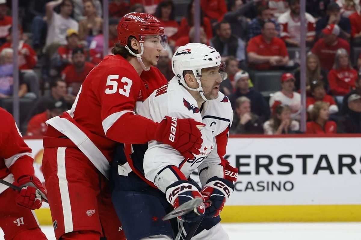 Apr 9, 2024; Detroit, Michigan, USA; Detroit Red Wings defenseman Moritz Seider (53) and Washington Capitals left wing Alex Ovechkin (8) fight for position in the third period at Little Caesars Arena.