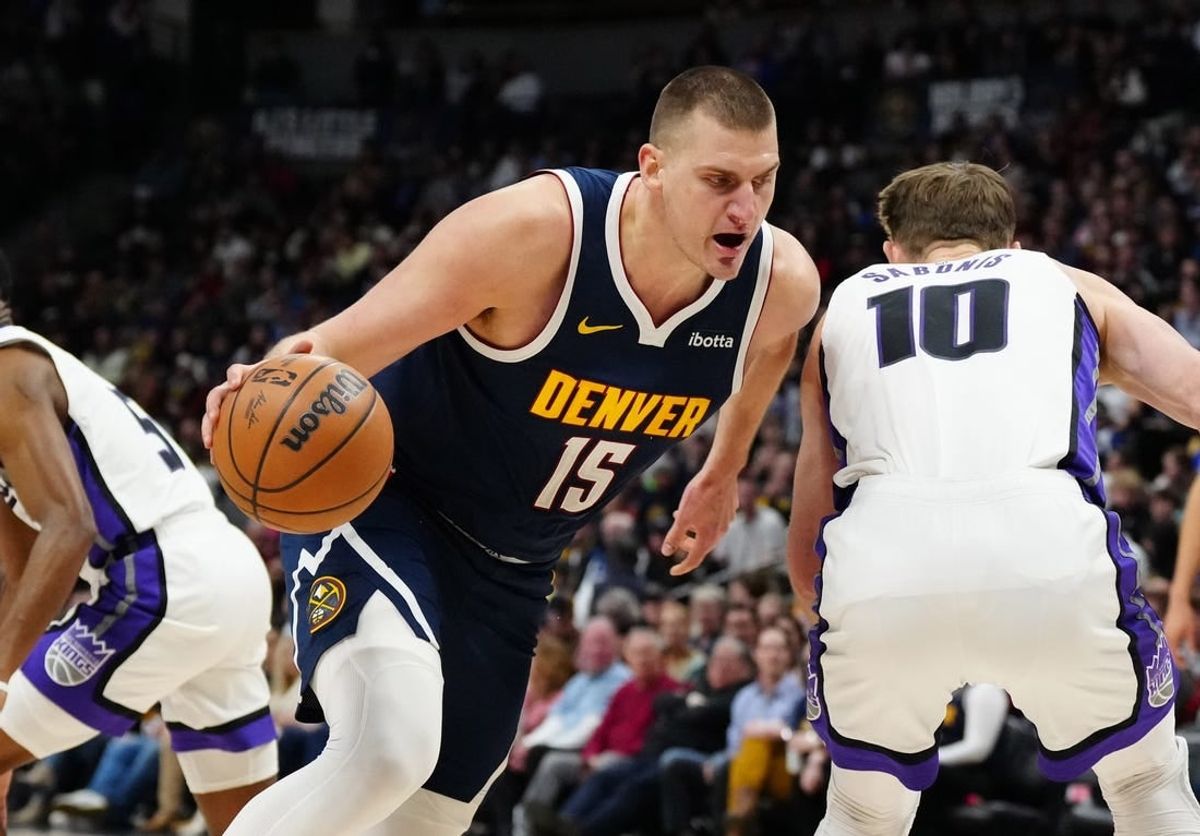 Feb 14, 2024; Denver, Colorado, USA; Denver Nuggets center Nikola Jokic (15) drives around Sacramento Kings forward Domantas Sabonis (10) in the first quarter at Ball Arena.