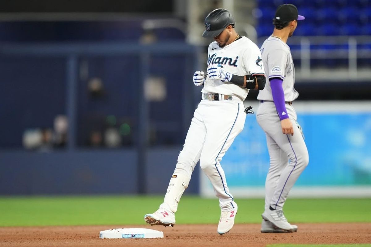 May 2, 2024; Miami, Florida, USA;  Miami Marlins second baseman Luis Arraez (3) hits a double in the first inning against the Colorado Rockies at loanDepot Park.