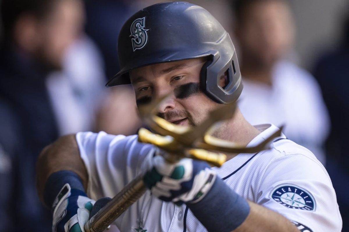 Apr 17, 2024; Seattle, Washington, USA; Seattle Mariners catcher Cal Raleigh (29) celebrates in the dugout after hitting a solo home run during the second inning against the Cincinnati Reds at T-Mobile Park.