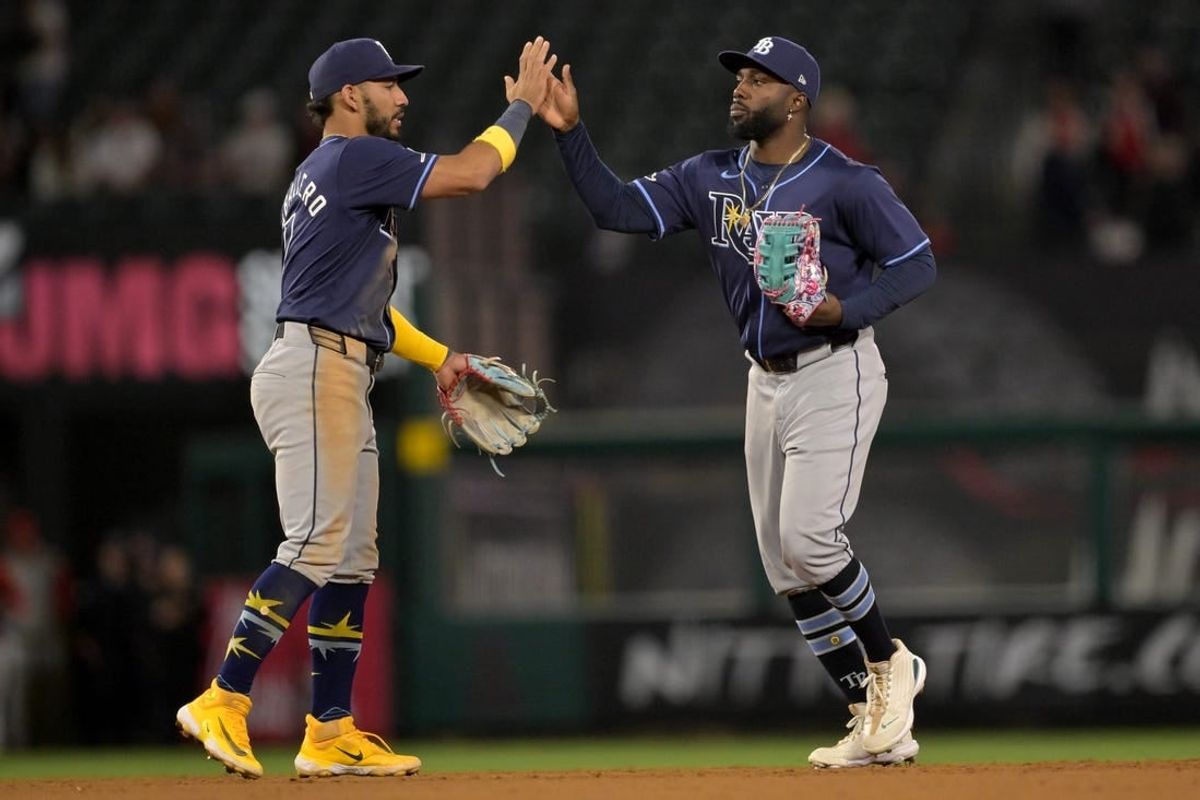 Apr 9, 2024; Anaheim, California, USA;  Tampa Bay Rays shortstop Jose Caballero (7) and outfielder Randy Arozarena (56) celebrate after the final out of the ninth inning to defeat the Los Angeles Angels at Angel Stadium.