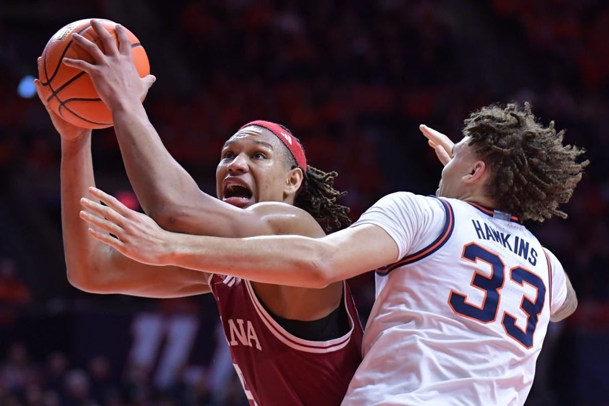 Jan 27, 2024; Champaign, Illinois, USA;  Indiana Hoosiers forward Malik Reneau (5) drives to the basket against Illinois Fighting Illini forward Coleman Hawkins (33) during the second half at State Farm Center.