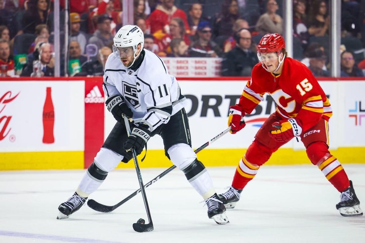 Mar 30, 2024; Calgary, Alberta, CAN; Los Angeles Kings center Anze Kopitar (11) controls the puck against the Calgary Flames during the third period at Scotiabank Saddledome.