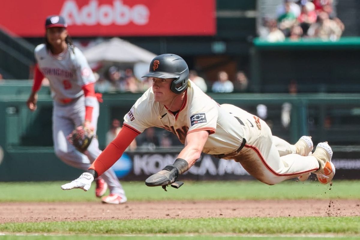 Apr 10, 2024; San Francisco, California, USA; San Francisco Giants shortstop Tyler Fitzgerald (49) slides headfirst into third base with a stolen base against the Washington Nationals during the second inning at Oracle Park.