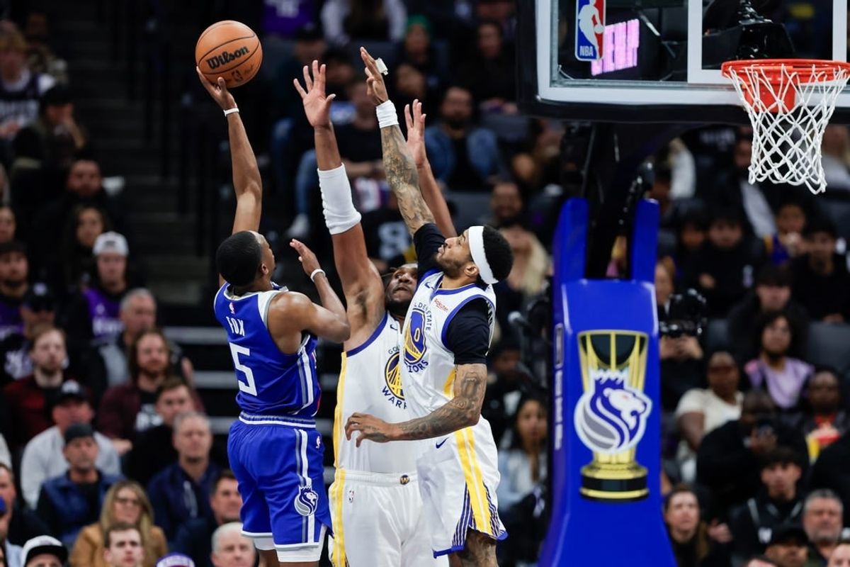 Nov 28, 2023; Sacramento, California, USA; Sacramento Kings guard De'Aaron Fox (5) shoots over Golden State Warriors guard Gary Payton II (0) during the third  quarter at Golden 1 Center.