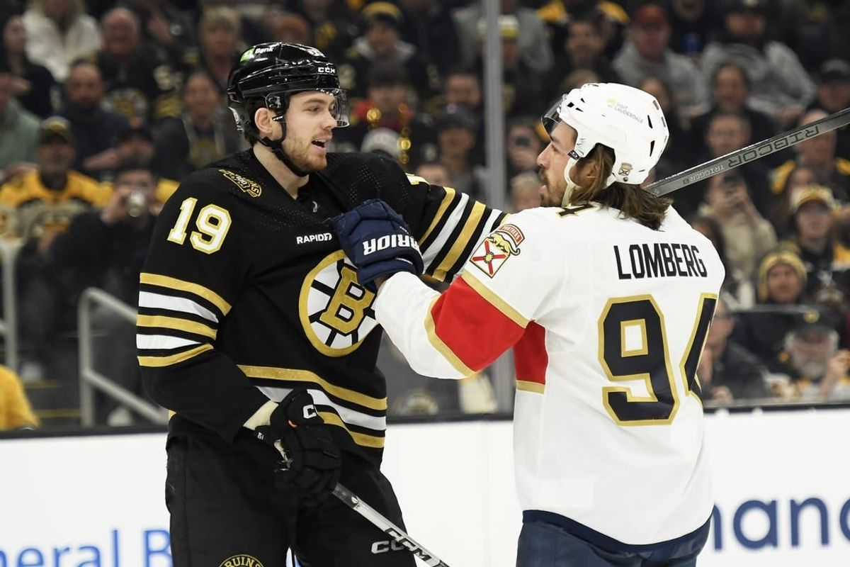 Apr 6, 2024; Boston, Massachusetts, USA; Boston Bruins center John Beecher (19) and Florida Panthers left wing Ryan Lomberg (94) grab each others jerseys during the first period at TD Garden.