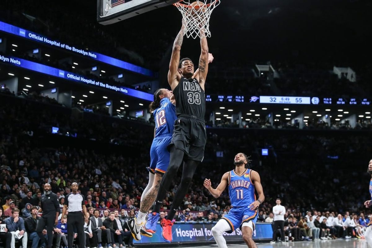 Jan 5, 2024; Brooklyn, New York, USA;  Brooklyn Nets center Nic Claxton (33) dunks past Oklahoma City Thunder forward Lindy Waters III (12) in the second quarter at Barclays Center.