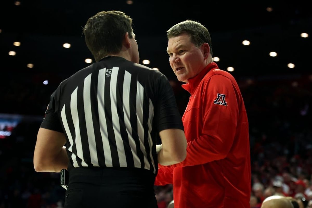Jan 20, 2024; Tucson, Arizona, USA; Arizona Wildcats head coach Tommy Lloyd talks to the referee during a timeout against the UCLA Bruins during the second half at McKale Center.