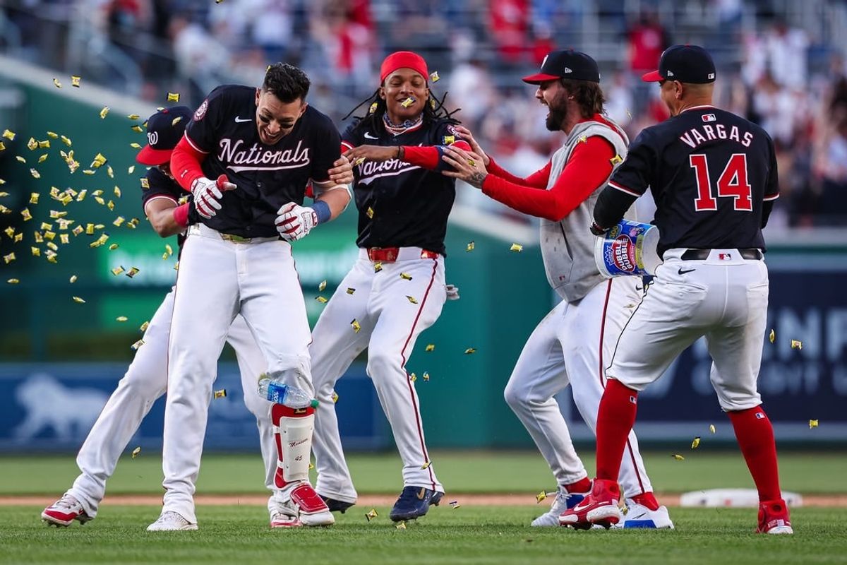 Apr 20, 2024; Washington, District of Columbia, USA; Washington Nationals first base Joey Meneses (45) celebrates with teammates on the field after hitting the game winning RBI single against the Houston Astros during the tenth inning at Nationals Park.