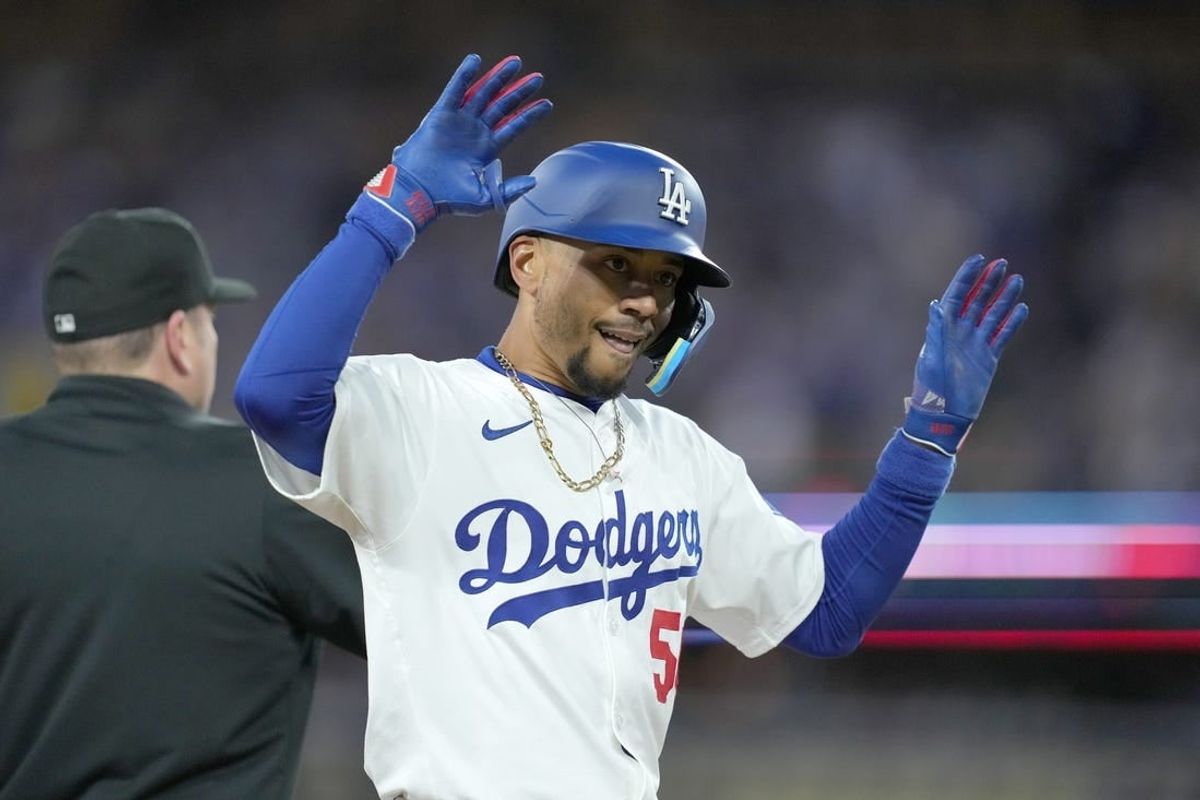 Apr 1, 2024; Los Angeles, California, USA; Los Angeles Dodgers shortstop Mookie Betts (50) reacts after hitting a triple in the first inning against the San Francisco Giants at Dodger Stadium.