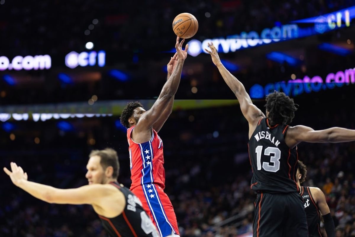 Dec 15, 2023; Philadelphia, Pennsylvania, USA; Philadelphia 76ers center Joel Embiid (21) shoots past Detroit Pistons center James Wiseman (13) during the second quarter at Wells Fargo Center.