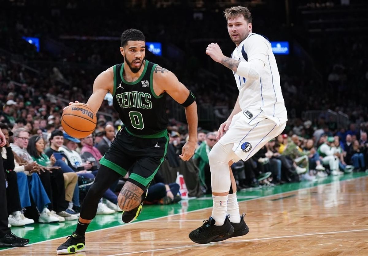 Mar 1, 2024; Boston, Massachusetts, USA; Boston Celtics forward Jayson Tatum (0) drives the ball against Dallas Mavericks guard Luka Doncic (77) in the second half at TD Garden.