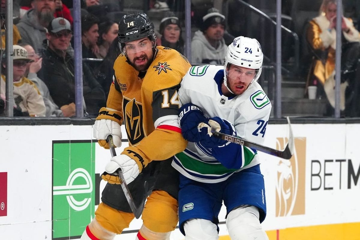 Mar 7, 2024; Las Vegas, Nevada, USA; Vegas Golden Knights defenseman Nicolas Hague (14) checks Vancouver Canucks center Pius Suter (24) during the first period at T-Mobile Arena.