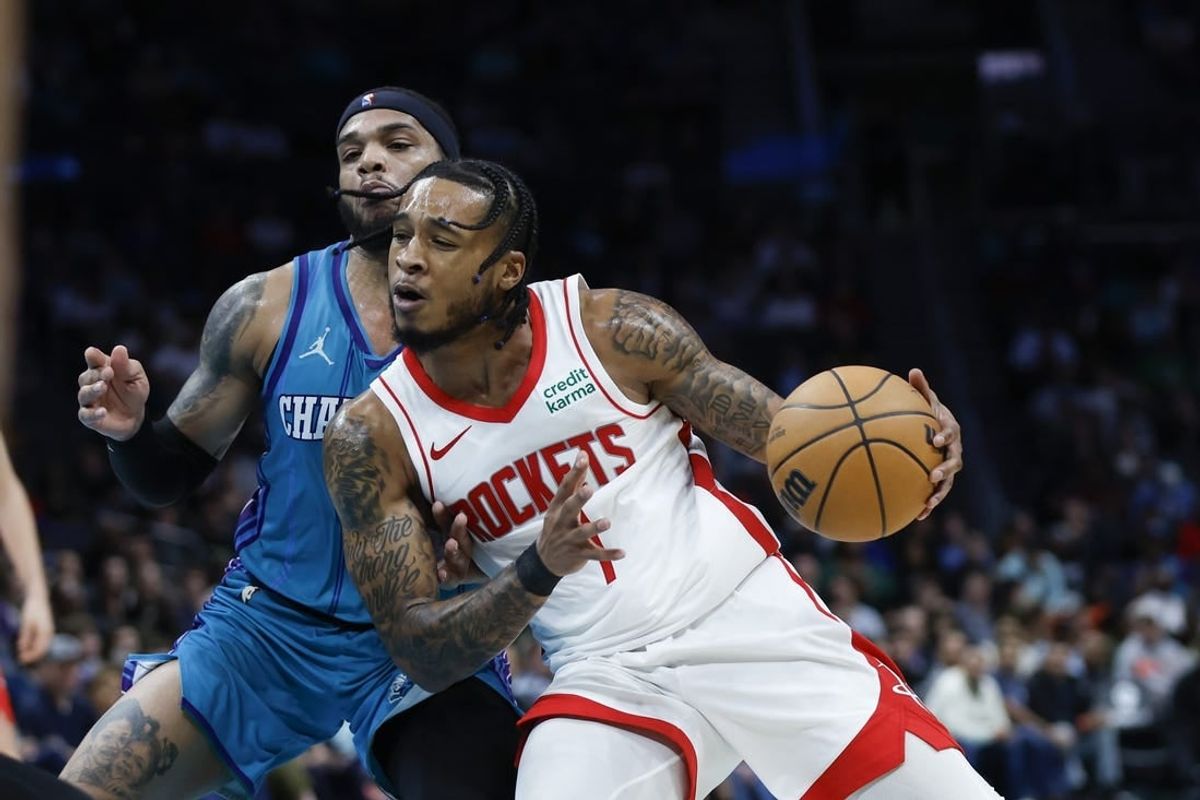 Jan 26, 2024; Charlotte, North Carolina, USA; Houston Rockets forward Cam Whitmore (7) moves against Charlotte Hornets forward Miles Bridges (0) during the second half at Spectrum Center.