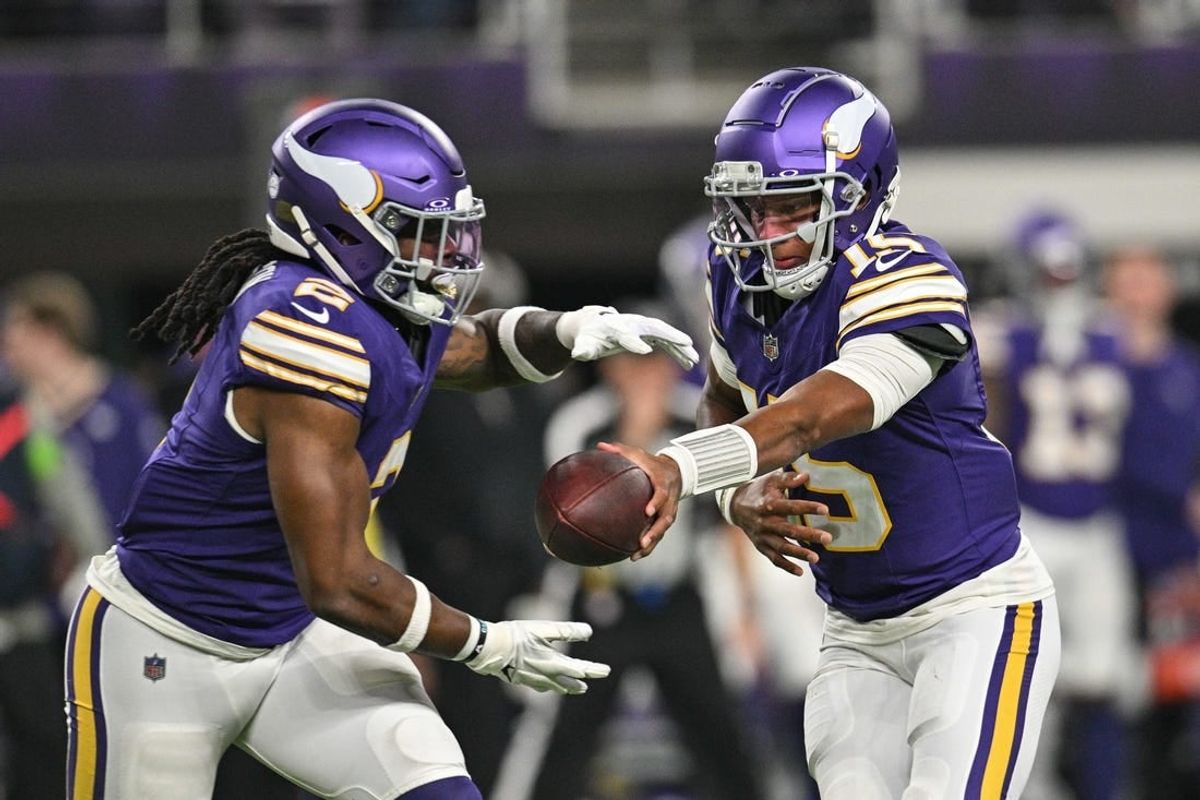 Nov 27, 2023; Minneapolis, Minnesota, USA; Minnesota Vikings quarterback Joshua Dobbs (15) hands the ball off to running back Alexander Mattison (2) during the game against the Chicago Bears at U.S. Bank Stadium.