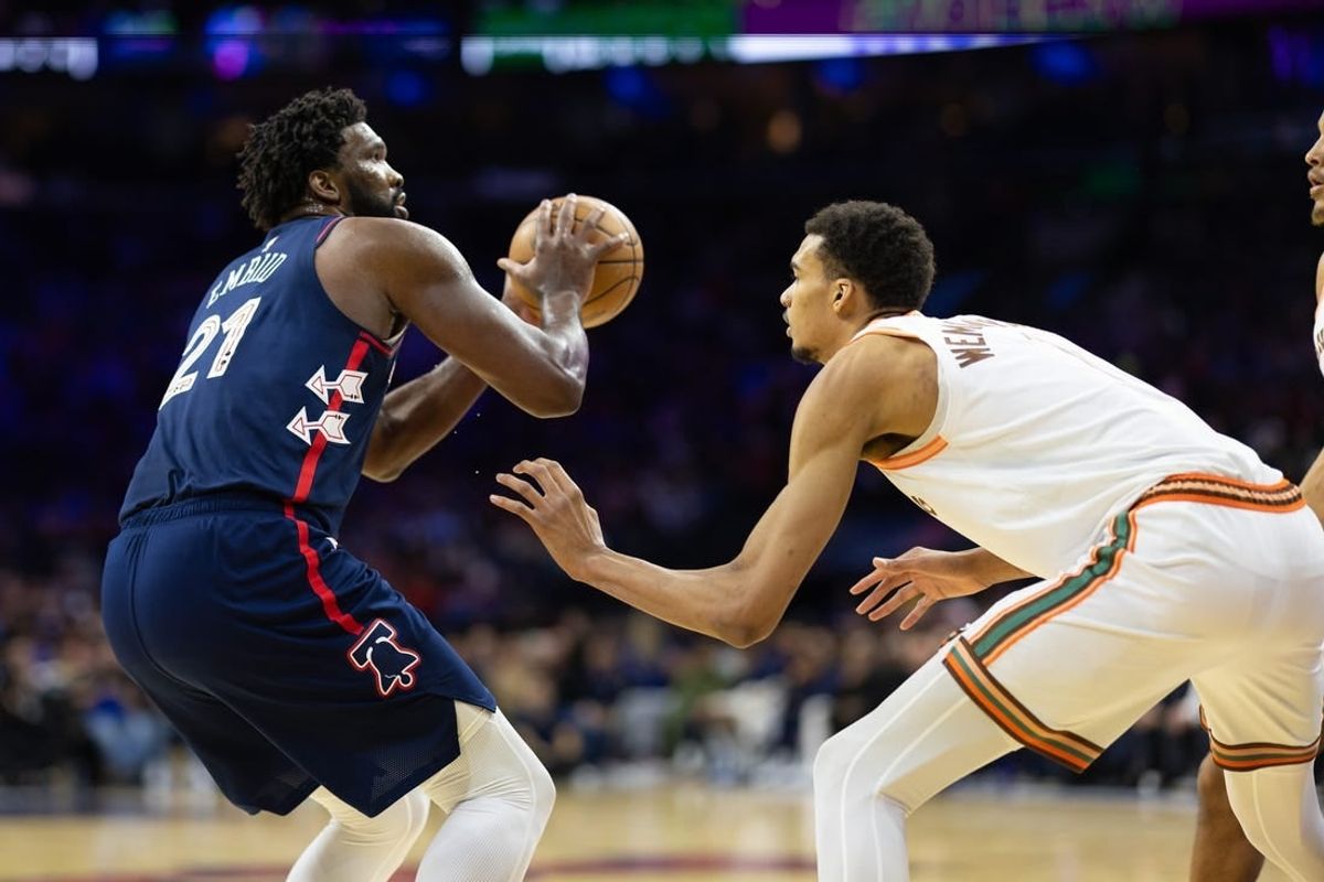 Jan 22, 2024; Philadelphia, Pennsylvania, USA; Philadelphia 76ers center Joel Embiid (21) shoots against San Antonio Spurs center Victor Wembanyama (1) during the second quarter at Wells Fargo Center.