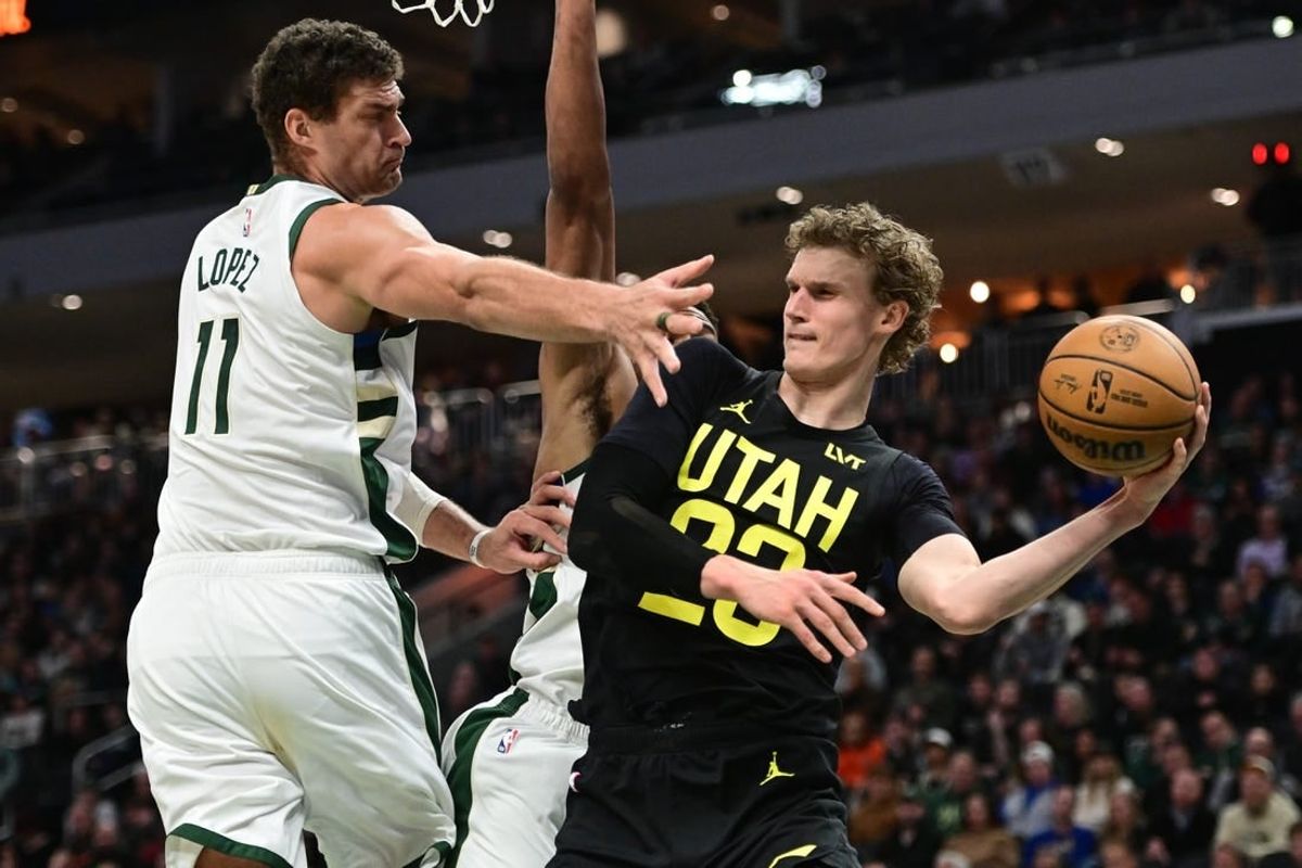 Jan 8, 2024; Milwaukee, Wisconsin, USA;  Utah Jazz forward Lauri Markkanen (23) looks to pass the ball away from Milwaukee Bucks center Brook Lopez (11) in the second quarter at Fiserv Forum.