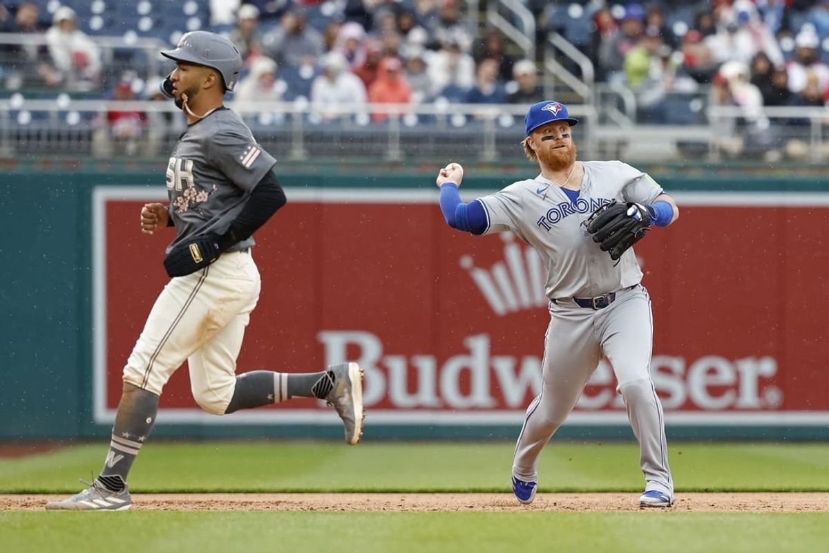 May 4, 2024; Washington, District of Columbia, USA; Toronto Blue Jays third base Justin Turner (2) makes a throw to first base on a ground ball by Washington Nationals third base Trey Lipscomb (not pictured) as Nationals outfielder Eddie Rosario (8) runs to third base during the second inning at Nationals Park.