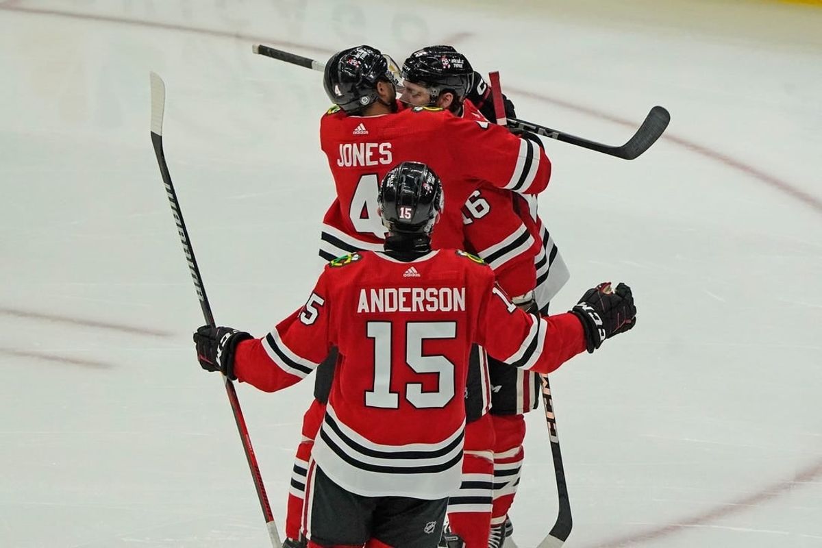 Nov 24, 2023; Chicago, Illinois, USA; Chicago Blackhawks center Jason Dickinson (16) celebrates his hat trick against the Toronto Maple Leafs during the third period at United Center.