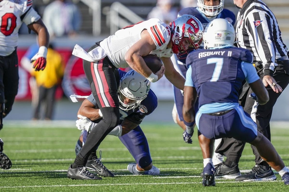 Dec 18, 2023; Charlotte, NC, USA; Western Kentucky Hilltoppers quarterback Caden Veltkamp (10) runs the ball against the Old Dominion Monarchs during the first quarter at Charlotte 49ers' Jerry Richardson Stadium.