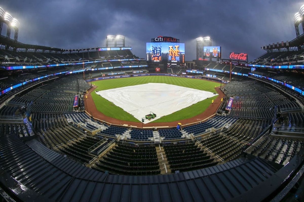Apr 2, 2024; New York City, New York, USA;  The tarp is placed on the field during a rain delay prior to the game between the Detroit Tigers and the New York Mets at Citi Field.