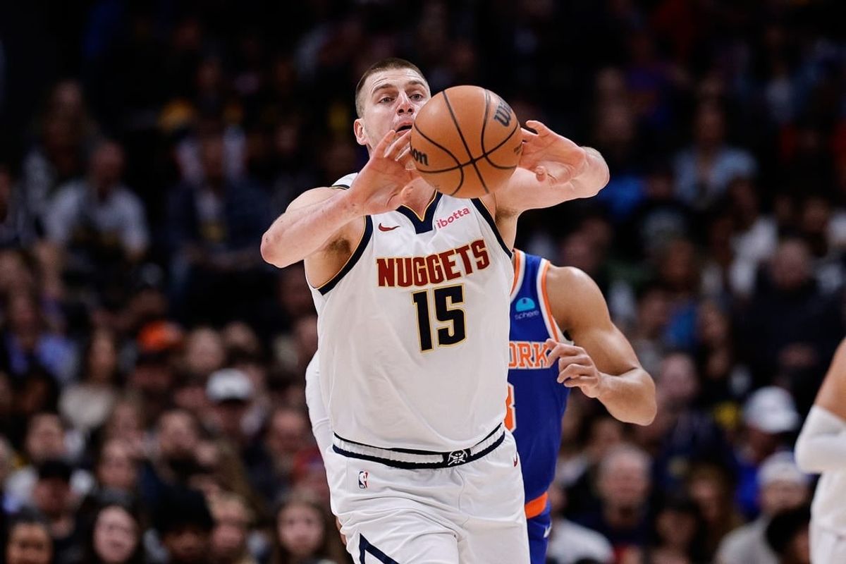 Mar 21, 2024; Denver, Colorado, USA; Denver Nuggets center Nikola Jokic (15) passes the ball in the first quarter against the New York Knicks at Ball Arena.