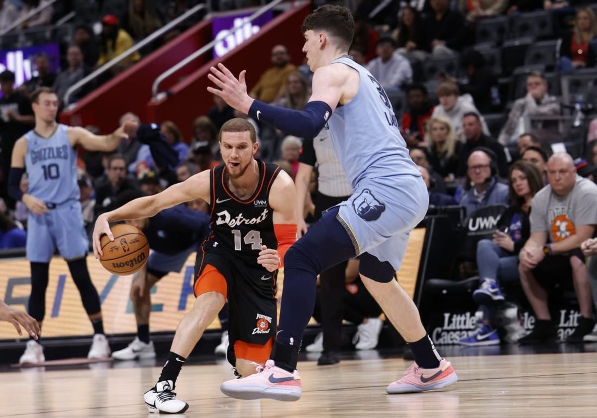 Apr 1, 2024; Detroit, Michigan, USA;  d14 dribbles defended by Memphis Grizzlies forward Jake LaRavia (3) in the first half at Little Caesars Arena.