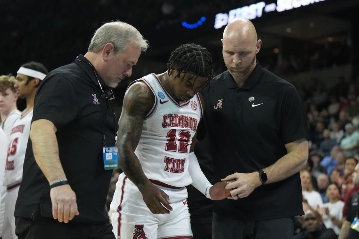 Mar 24, 2024; Spokane, WA, USA; Alabama Crimson Tide guard Latrell Wrightsell Jr. (12) is attended to by official in the first half against the Grand Canyon Antelopes at Spokane Veterans Memorial Arena.