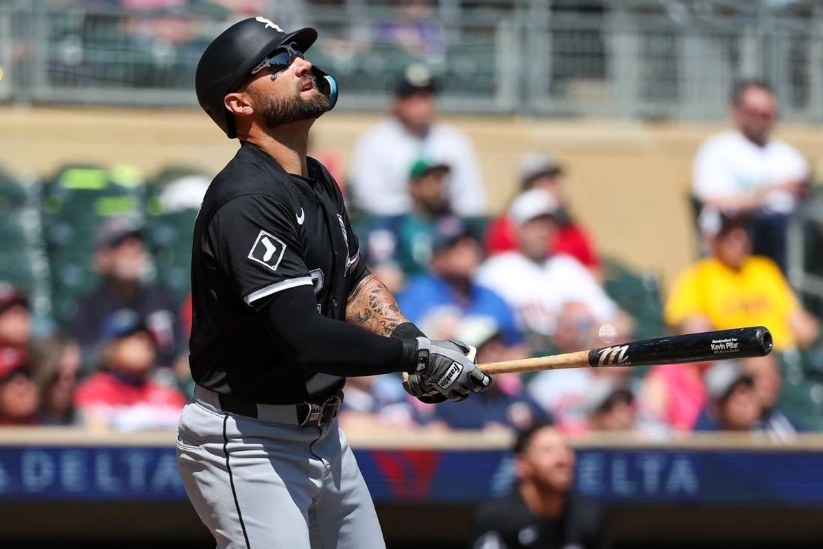 Apr 25, 2024; Minneapolis, Minnesota, USA; Chicago White Sox center fielder Kevin Pillar (12) hits an RBI sacrifice fly against the Minnesota Twins during the second inning at Target Field.