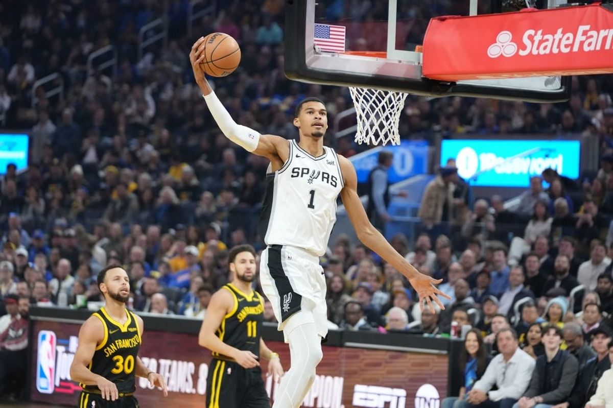November 24, 2023; San Francisco, California, USA; San Antonio Spurs center Victor Wembanyama (1) dunks the basketball against Golden State Warriors guard Stephen Curry (30) and guard Klay Thompson (11) during the first quarter at Chase Center.