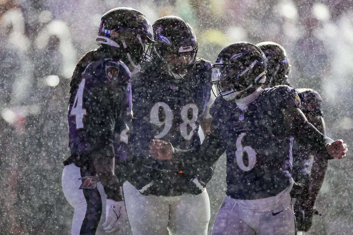Patrick Queen of the Baltimore Ravens talks with Jadeveon Clowney during a timeout in the fourth quarter of a game against the Pittsburgh Steelers.