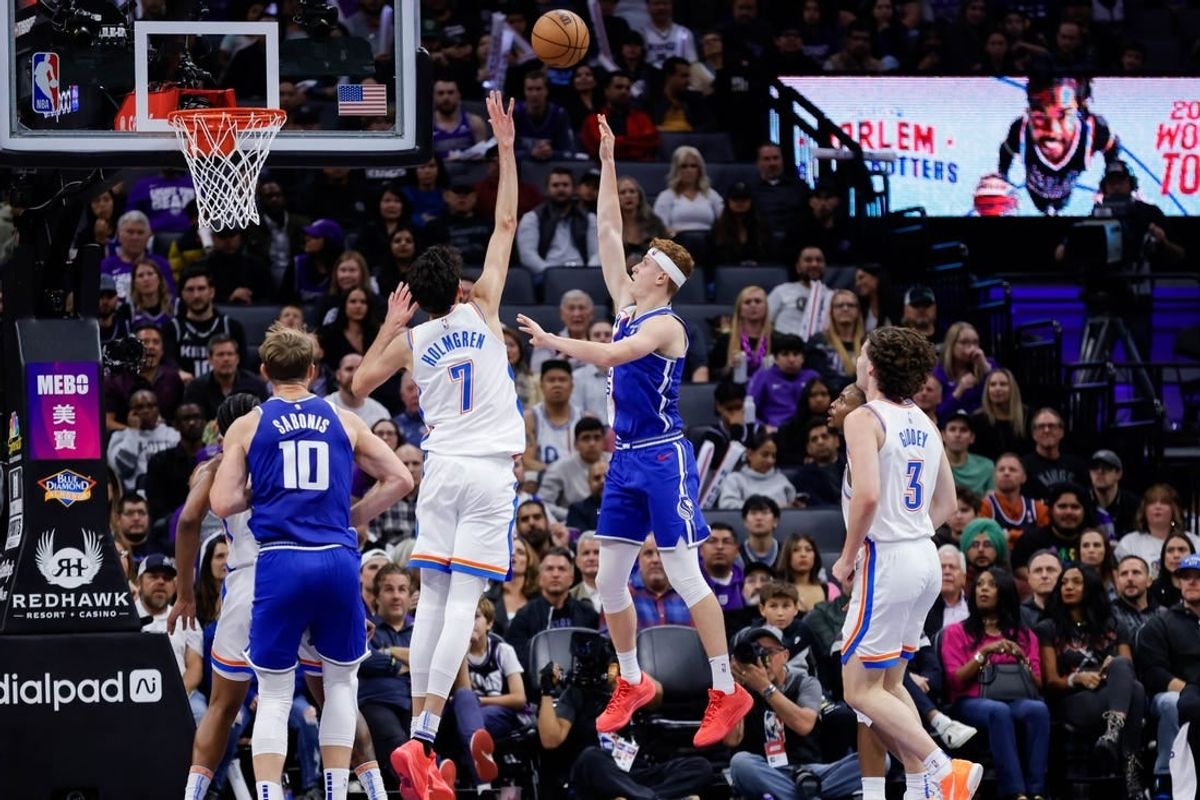 Nov 10, 2023; Sacramento, California, USA; Sacramento Kings guard Kevin Huerter (9) shoots the ball over Oklahoma City Thunder forward Chet Holmgren (7) during the second quarter at Golden 1 Center.