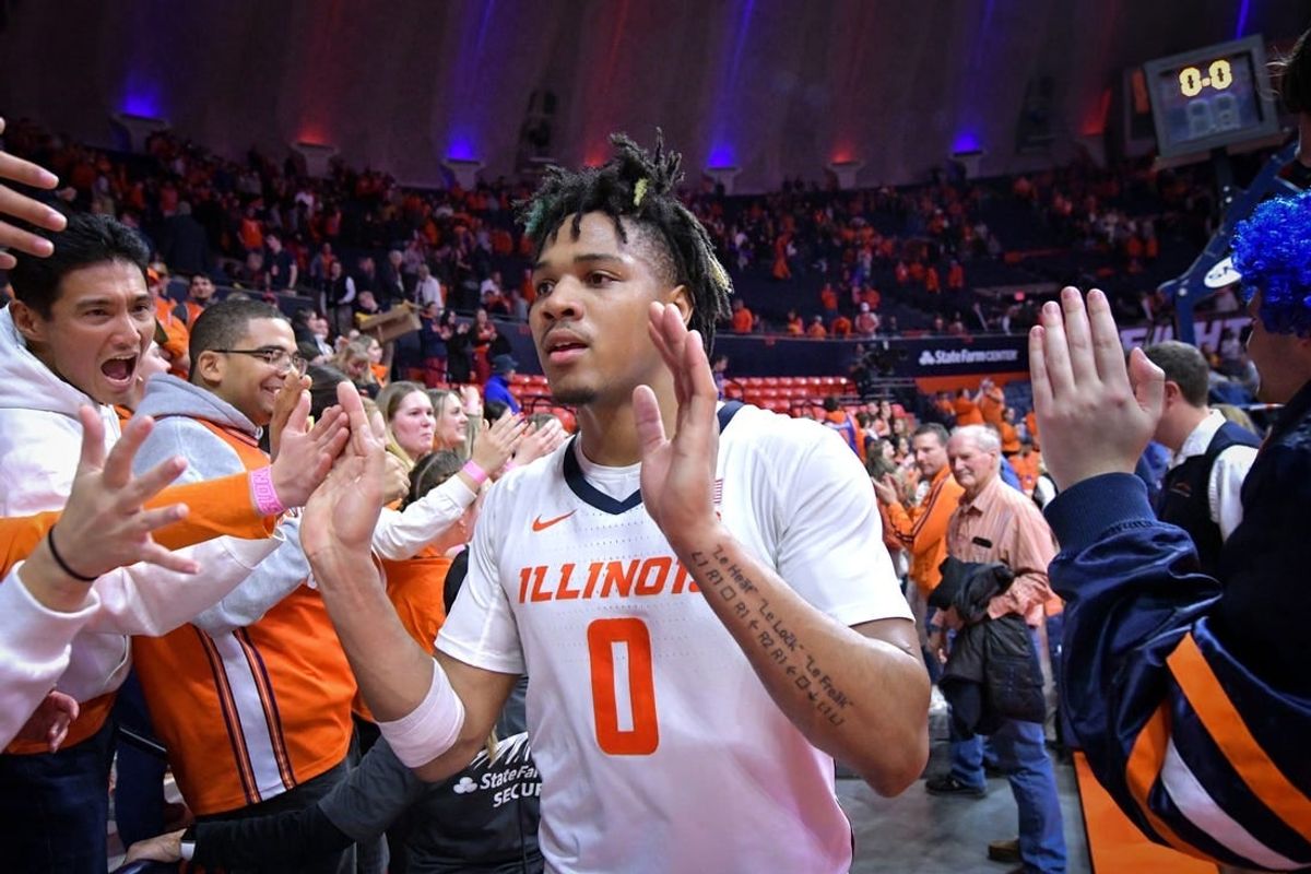 Feb 4, 2024; Champaign, Illinois, USA;  Illinois Fighting Illini forward Ty Rodgers (20) gets a hand from the fans after a 87-84 win over the Nebraska Cornhuskers at State Farm Center.