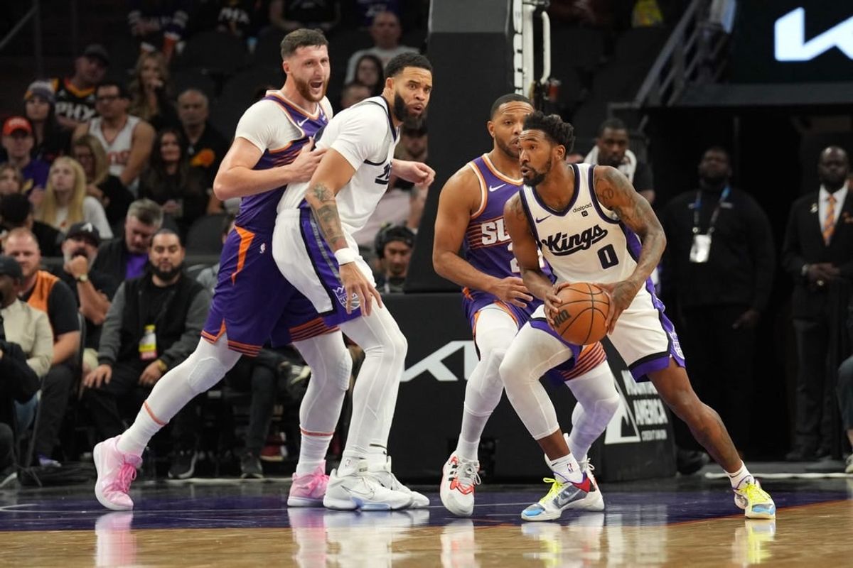 Dec 8, 2023; Phoenix, Arizona, USA; Sacramento Kings guard Malik Monk (0) controls the ball against the Phoenix Suns during the first half at Footprint Center.