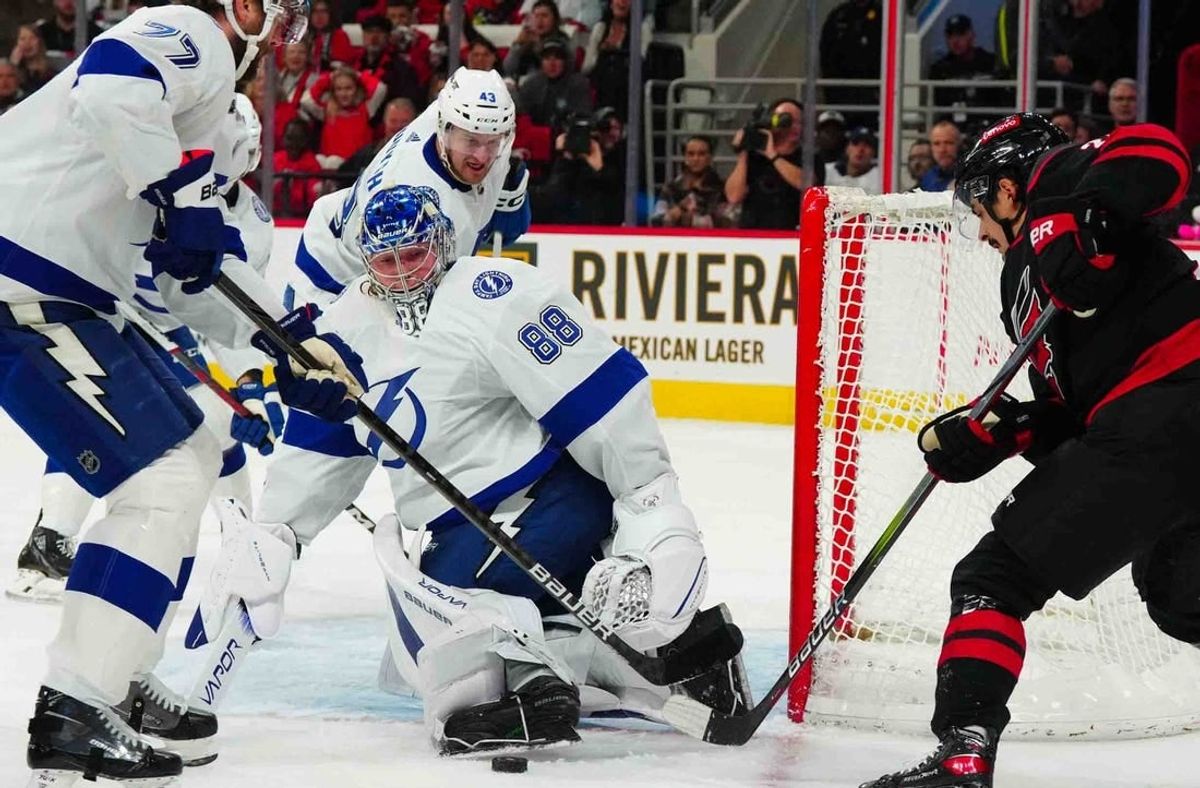 Nov 24, 2023; Raleigh, North Carolina, USA; Tampa Bay Lightning goaltender Andrei Vasilevskiy (88) stops the scoring attempt by Carolina Hurricanes center Seth Jarvis (24) during the first period at PNC Arena.