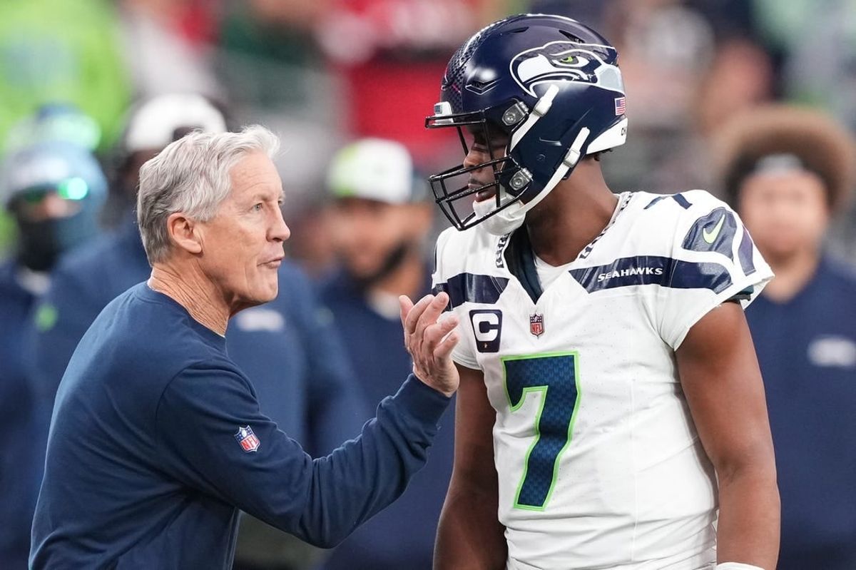 Jan 7, 2024; Glendale, Arizona, USA; Seattle Seahawks head coach Pete Carroll talks with Seattle Seahawks quarterback Geno Smith (7) during the first half of the game against the Arizona Cardinals at State Farm Stadium.