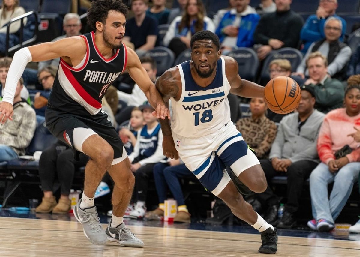 Jan 12, 2024; Minneapolis, Minnesota, USA; Minnesota Timberwolves guard Shake Milton (18) is defended by Portland Trail Blazers forward Justin Minaya (24) in the fourth quarter at Target Center.