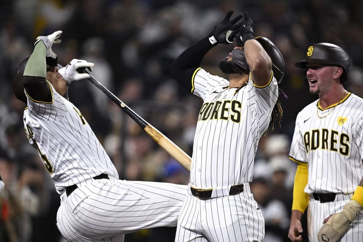 Apr 8, 2024; San Diego, California, USA; San Diego Padres right fielder Fernando Tatis Jr. (center) celebrates with designated hitter Manny Machado (13) after hitting a two-run home run against the Chicago Cubs during the eighth inning at Petco Park.