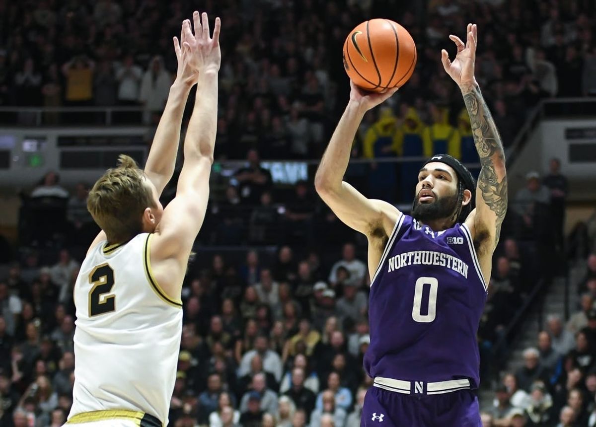 Jan 31, 2024; West Lafayette, Indiana, USA; Northwestern Wildcats guard Boo Buie (0) attempts a shot over Purdue Boilermakers guard Fletcher Loyer (2) during the first half at Mackey Arena.