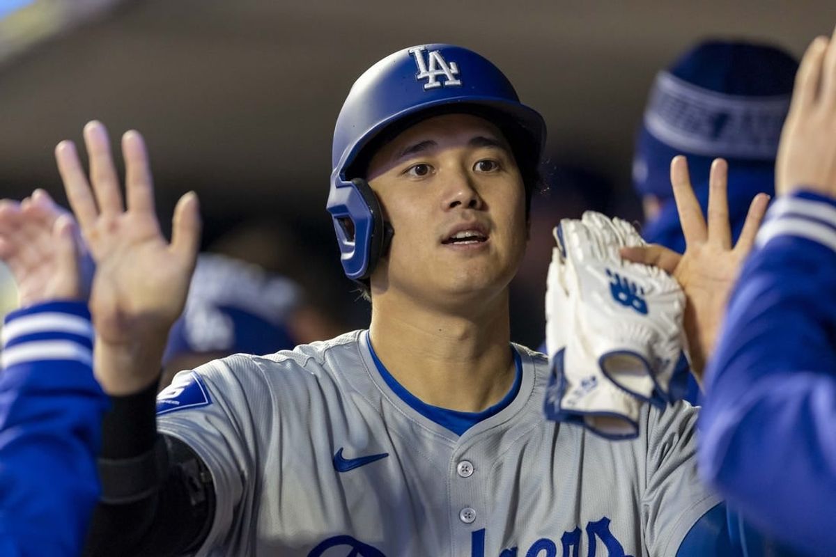 Apr 8, 2024; Minneapolis, Minnesota, USA; Los Angeles Dodgers designated hitter Shohei Ohtani (17) celebrates after scoring a run against the Minnesota Twins in the sixth inning at Target Field.