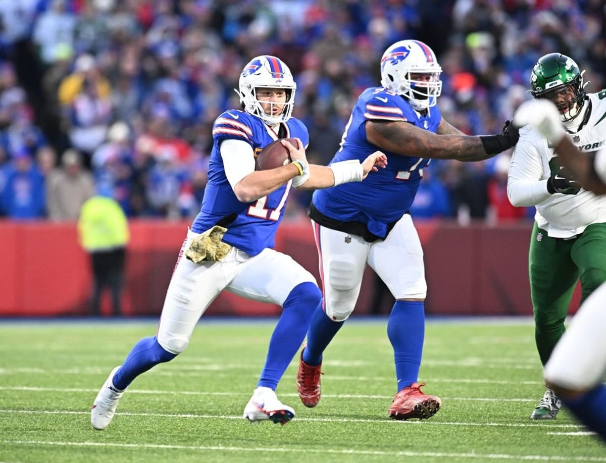 Nov 19, 2023; Orchard Park, New York, USA; Buffalo Bills quarterback Josh Allen (17) runs for a first down against the New York Jets in the first quarter at Highmark Stadium.