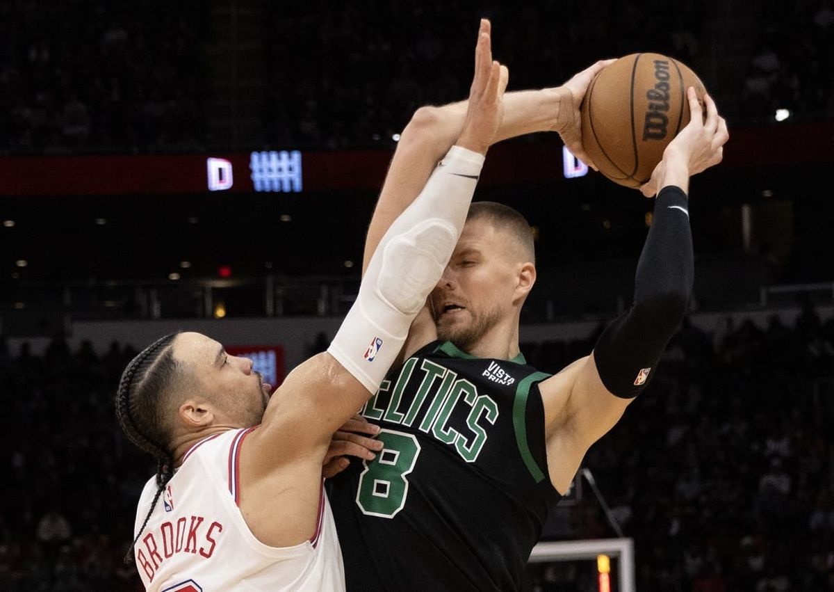 Jan 21, 2024; Houston, Texas, USA; Boston Celtics center Kristaps Porzingis (8) is guarded by Houston Rockets forward Dillon Brooks (9) in the second half at Toyota Center.