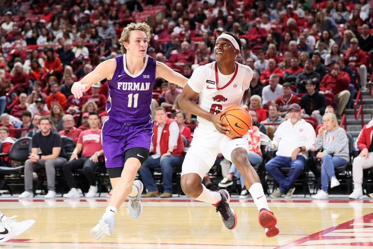 Dec 4, 2023; Fayetteville, Arkansas, USA; Arkansas Razorbacks guard Layden Blocker (6) drives against Furman Paladins guard Carter Whitt (11) during the first half at Bud Walton Arena.
