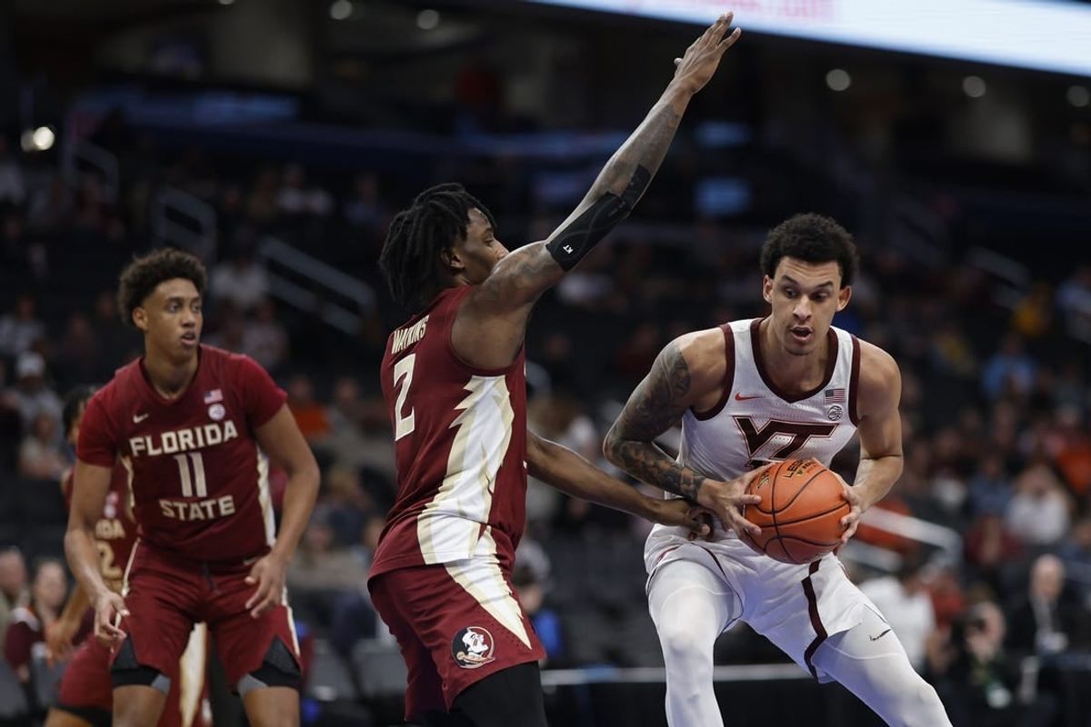 Mar 13, 2024; Washington, D.C., USA; Virginia Tech Hokies center Lynn Kidd (15) drives to the basket as Florida State Seminoles forward Jamir Watkins (2) defends in the first half at Capital One Arena.