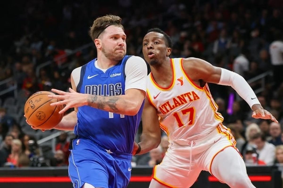 Jan 26, 2024; Atlanta, Georgia, USA; Dallas Mavericks guard Luka Doncic (77) moves past Atlanta Hawks forward Onyeka Okongwu (17) in the first quarter at State Farm Arena.